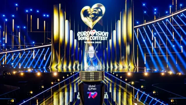 The Eurovision Song Contest trophy, on the stage of the 2026 competition, illuminated by gold and blue lighting