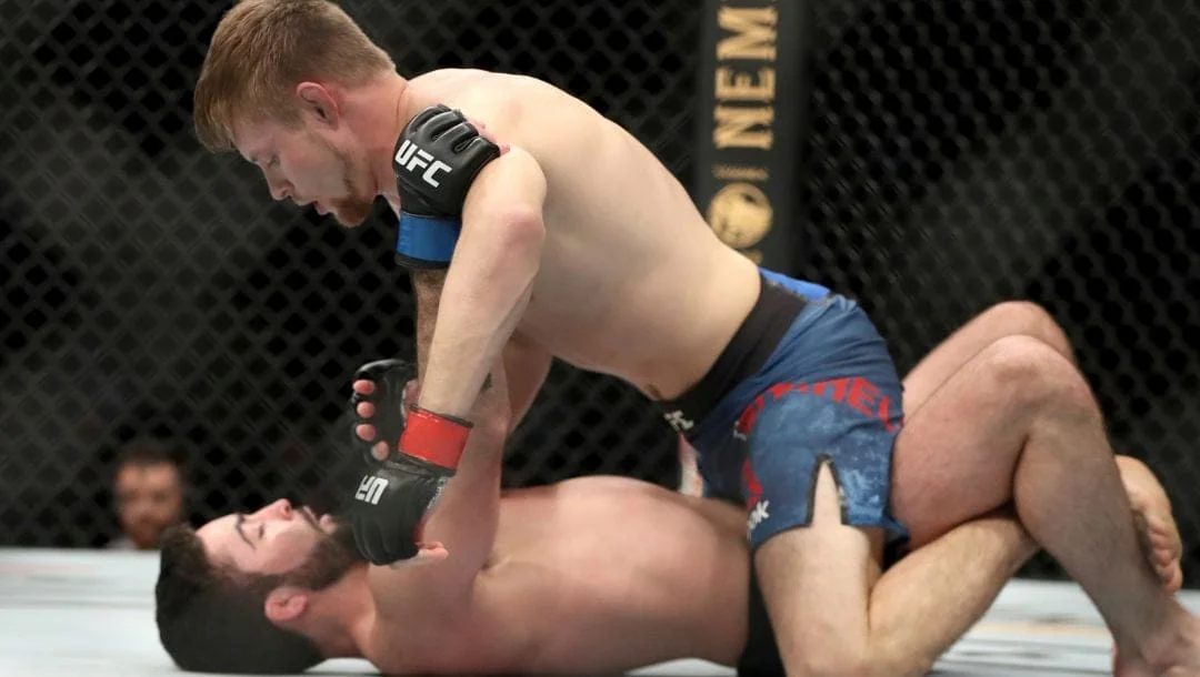 Bryce Mitchell, top, in action against Matt Sayles during their mixed martial arts bout at UFC Fight Night.