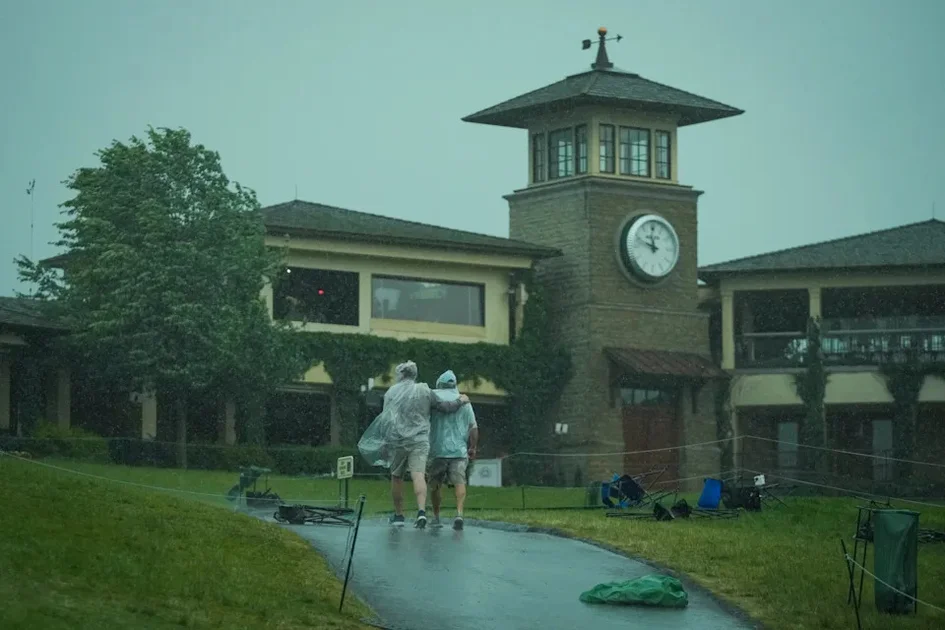 Patrons take cover during a weather delay during the third round of the Memorial Tournament at Muirfield Village Golf Club on June 6, 2026.