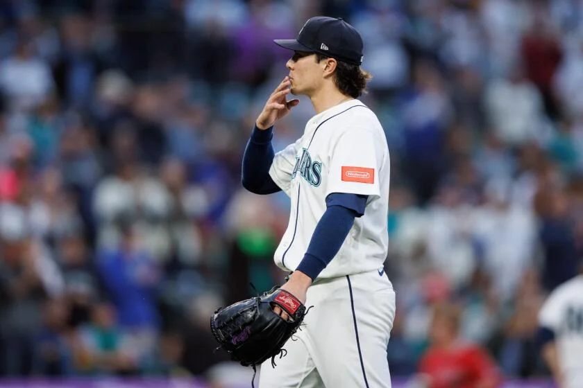 Seattle Mariners pitcher Bryan Woo reacts after being relieved in the sixth inning of a baseball game against the Los Angeles Angels, Tuesday, June 30, 2026, in Seattle. (AP Photo/Kevin Ng)