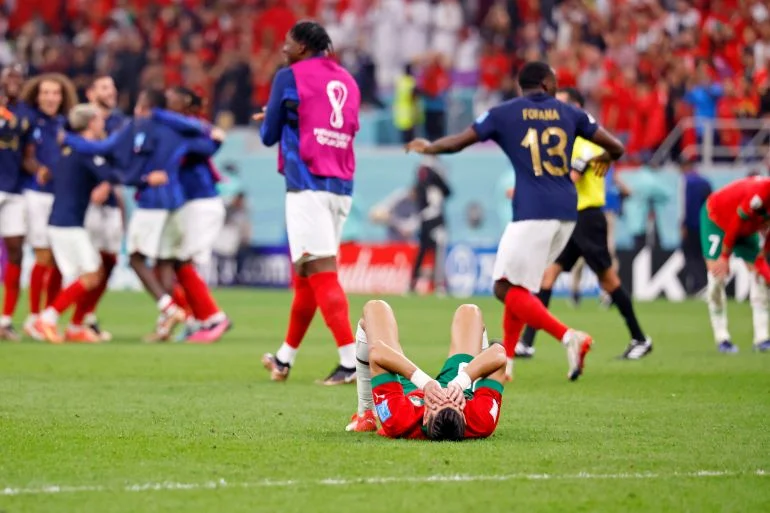 Morocco defender Jawad El Yamiq (18) on the floor as France celebrate
