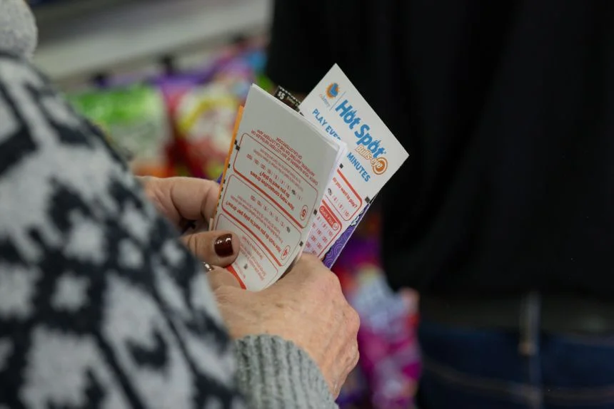 Ellen Adelman waits in line with her lottery tickets at Bluebird Liquor on Monday, December 1, 2025, in Hawthorne, California.