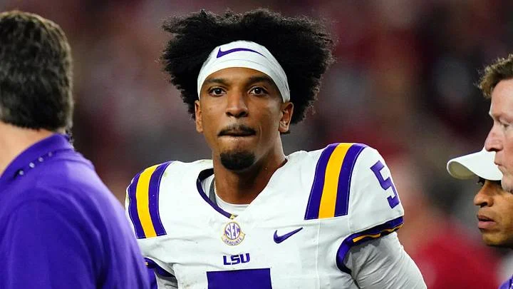 LSU Tigers quarterback Jayden Daniels (5) is helped off the field with trainers and medical staff after being hit by the Alabama Crimson Tide defense during the second half at Bryant-Denny Stadium. After review Alabama was penalized with roughing the passer.