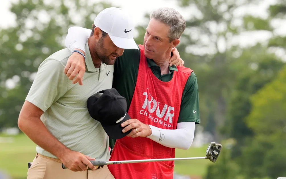 Scottie Scheffler and his caddie Ted Scott on the 18th green after final round of the 2024 Tour Championship. (John David Mercer-USA TODAY Sports)