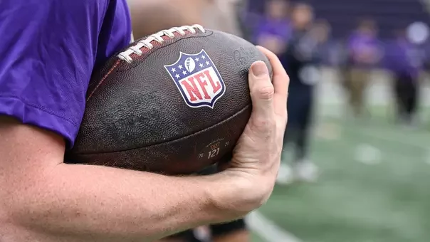 A JMU senior holds an NFL football during the 2026 Pro Day at Bridgeforth Stadium.