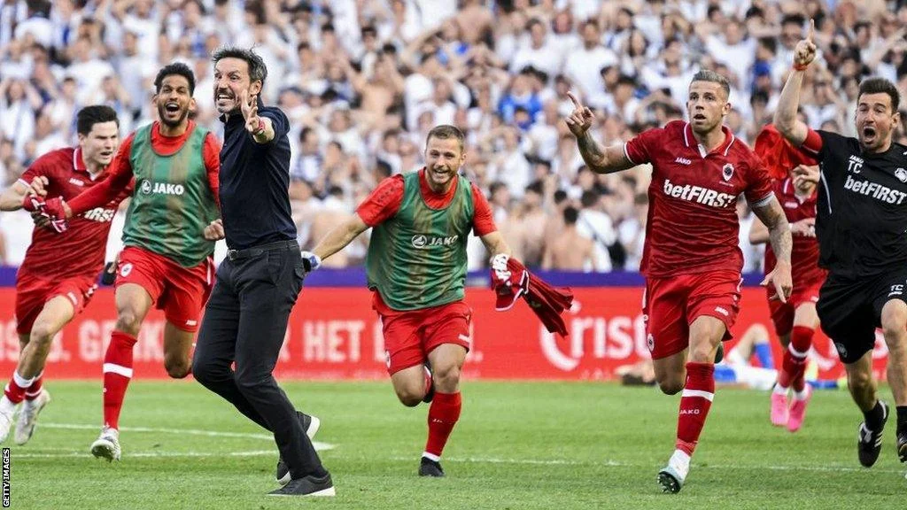 Royal Antwerp coach Mark van Bommel celebrates with his players after Toby Alderweireld scores in stoppage time to win the Belgian league title