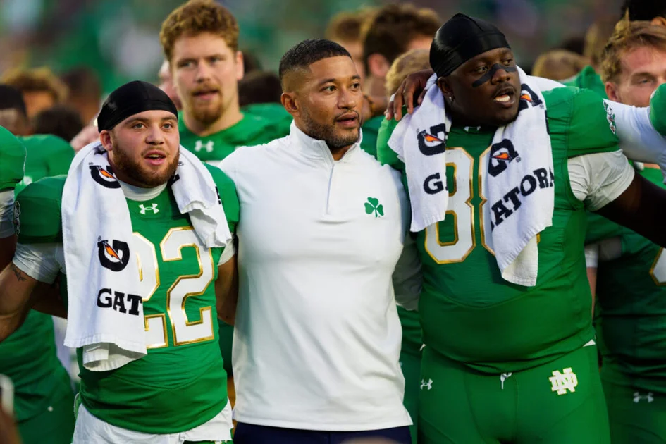 Notre Dame head coach Marcus Freeman, center, celebrates with his team after winning a NCAA football game 58-7 against Stanford